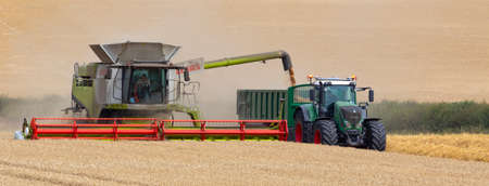 A combine harvester working in a field of wheat in North Yorkshire in the United Kingdom.のeditorial素材