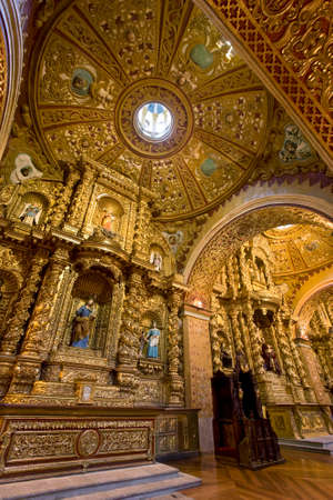 The interior of La Compania Jesuit Church in Quito in Ecuador in South America. Much of the ornate sculpture is made from local volcanic pumice which has then been covered in gold leaf (supposedly 7 tons of it)のeditorial素材