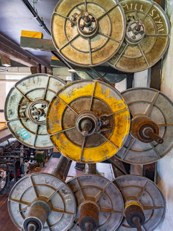 Large metal bobbins in the spares department and workshop in Quarry Bank Mill (also known as Styal Mill) in Styal, Cheshire, in northwest England. It is one of the best preserved textile factories of the Industrial Revolution. Quarry Bank Mill was establiのeditorial素材