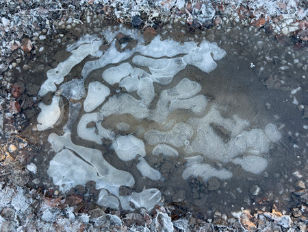 Winter weather - a frozen puddle of water on a farm track.の写真素材