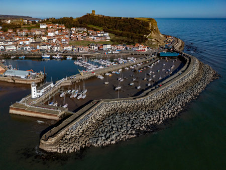 Aerial view of the lighthouse and harbor in the seaside town of Scarborough on the North Yorkshire coast of England.の写真素材