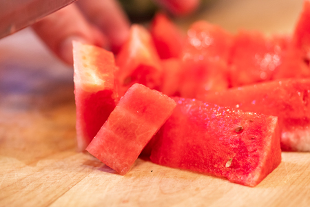 Hands slicing watermelonの写真素材
