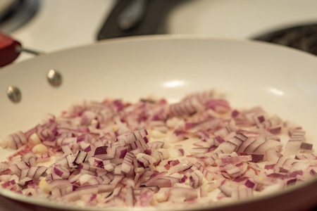 Chopped red onion in frying pan.の写真素材
