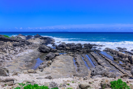 Tropical beach with rocks and turquoise water in Okinawaの写真素材