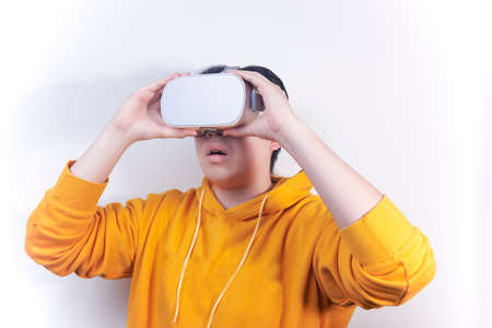 A man wearing VR glasses shows a shocking expressionの写真素材