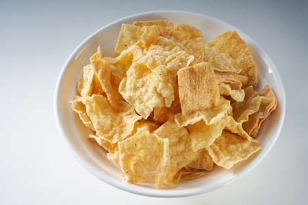 Closeup of a bowl of golden tempting fried yuba