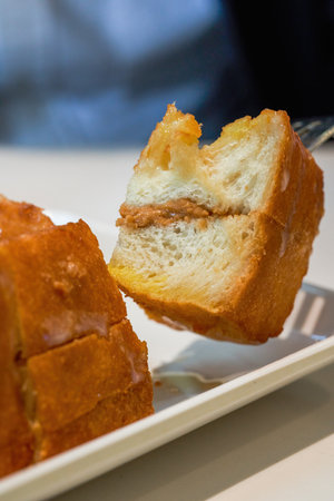 Classic dessert in Hong Kong tea restaurant, deep-fried western toast with condensed milk and peanut...