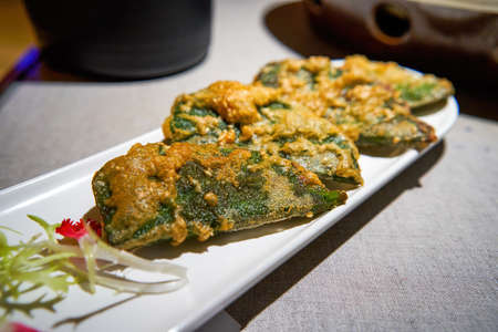 Delicious traditional Chinese Guangxi food snacks, fried beef Piper sarmentosum Roxbの写真素材