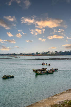 Fishing boats and bamboo fishing nets for fishermen by the seaの写真素材