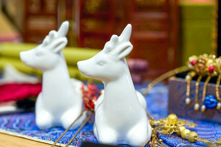 Two white ceramic unicorn wildebeest toysの写真素材