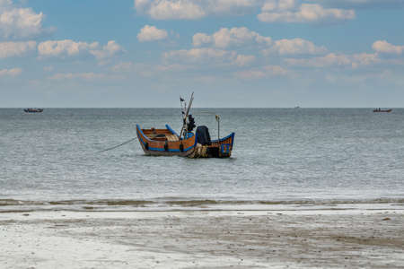 Close-up of fishing boats docked on the beach by the seaの写真素材
