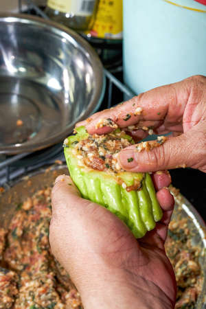 A chef is making a traditional Chinese dish from Guangxi, bitter gourd stuffed with meatの写真素材