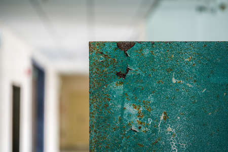 Close-up of a green painted rusty textured iron box indoor
