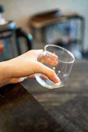 Close-up of a lady holding a wine glass in a barの写真素材