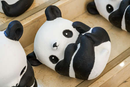 Close-up of a group of ceramic graffiti panda dollsのeditorial素材