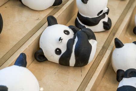 Close-up of a group of ceramic graffiti panda dollsのeditorial素材