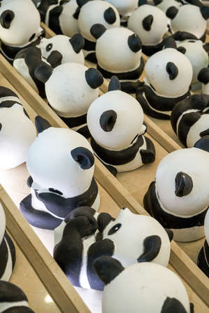 Close-up of a group of ceramic graffiti panda dollsのeditorial素材