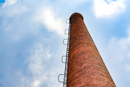 Abandoned red brick factory building and big chimneyの写真素材