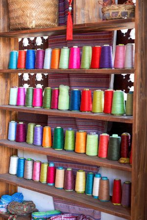 The cabinets of the Chinese tailor shop are filled with cotton thread spools of various colors