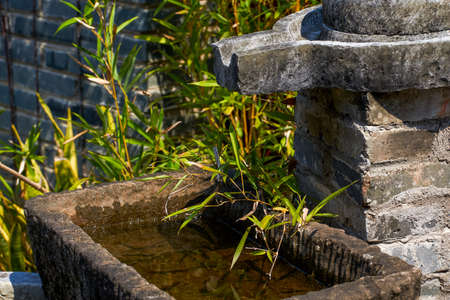 Stone mill running water pool in Chinese classical gardenの写真素材