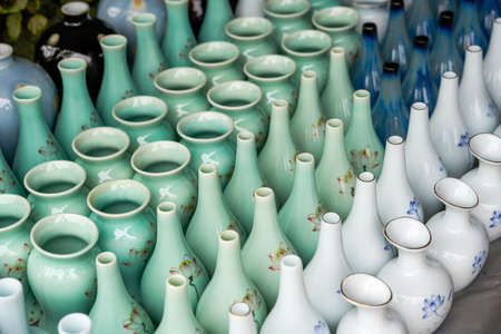 Various neat ceramic colored vases for sale at flower marketの写真素材