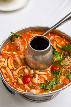 A pot of hot and sour Thai Tom Yum soup