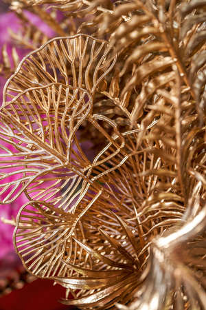 Decorative grass leaves sprayed with gold paint for sale in a flower shop