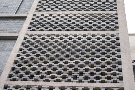 Facade wall of city building made of grey bricks
