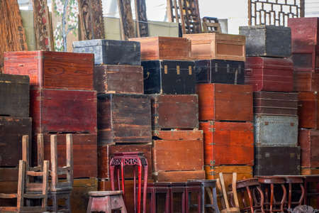 Pile of old vintage big wooden boxes stacked in a furniture storeの写真素材