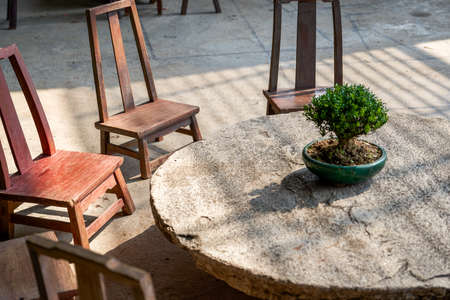 Close up of stone round table and wooden stools in Chinese gardenの写真素材