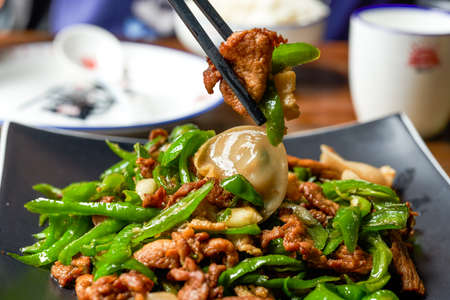 A plate of delicious and spicy Hunan dishes, fried pork with chiliの写真素材