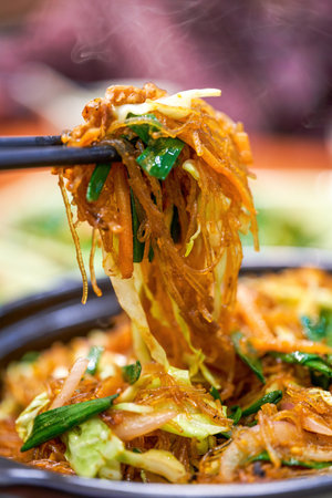 A delicious Chinese dish, vegetarian stir-fried vermicelli in clay potの写真素材