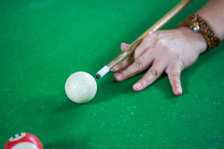 Close-up of a pool player playing poolの写真素材