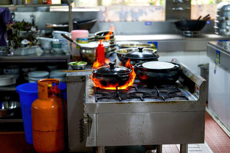 Cantonese dishes on the stovetop in a kei ke pot drizzled with white wine flamesの写真素材