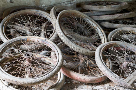 Pile of used bicycle wheels in an abandoned garbage dump