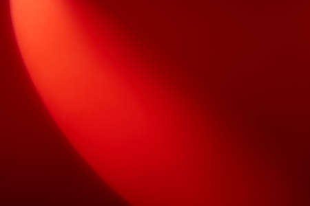 A semicircle of lights hits a red backgroundの写真素材