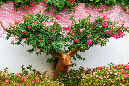Romantic flower sika deer head and antlers statue in the gardenの写真素材