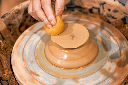 Craftsmen in pottery shop making clay potteryの写真素材