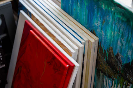 Frames and works stacked in an oil painting studioの写真素材