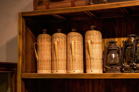 Vintage bamboo braided kettle and kerosene lamp