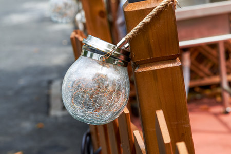 Closeup of lamps hanging in outdoor gardenの写真素材