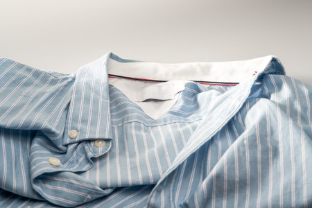 Partial closeup of a light blue striped shirtの写真素材