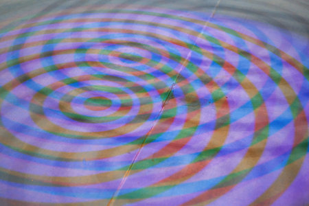 Close-up of colorful ring light projected onto the ground by colorful ring lightsの写真素材