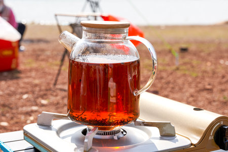 A pot of black tea burned in a picnic campingの写真素材