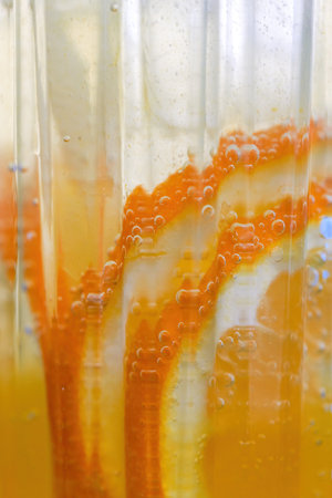 A cup of refreshing orange sparkling water drink in summerの写真素材