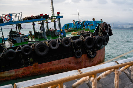 Large fishing boats docked by the sea in Hong Kong