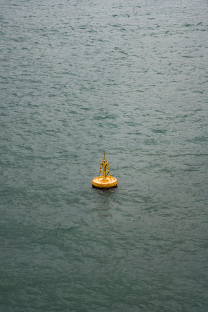 Yellow ship navigation beacon on the seaの写真素材