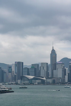 The tall financial center building and surrounding bustling buildings in Central, Hong Kong