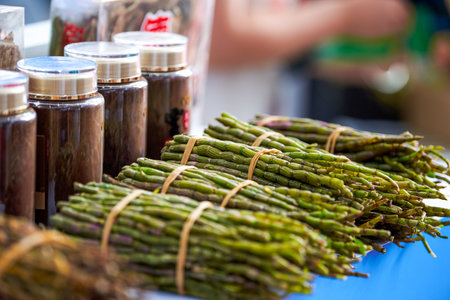Bunch of fresh green asparagus on display at a farmers marketの写真素材