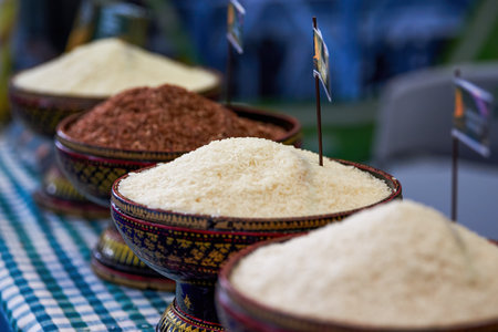 Close up of different types of rice in bowls on a market stallの写真素材